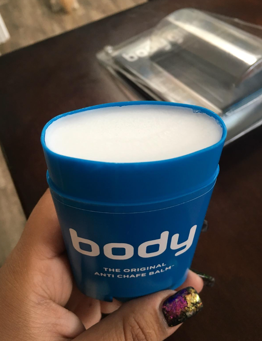 Reviewer holding the balm in their hand