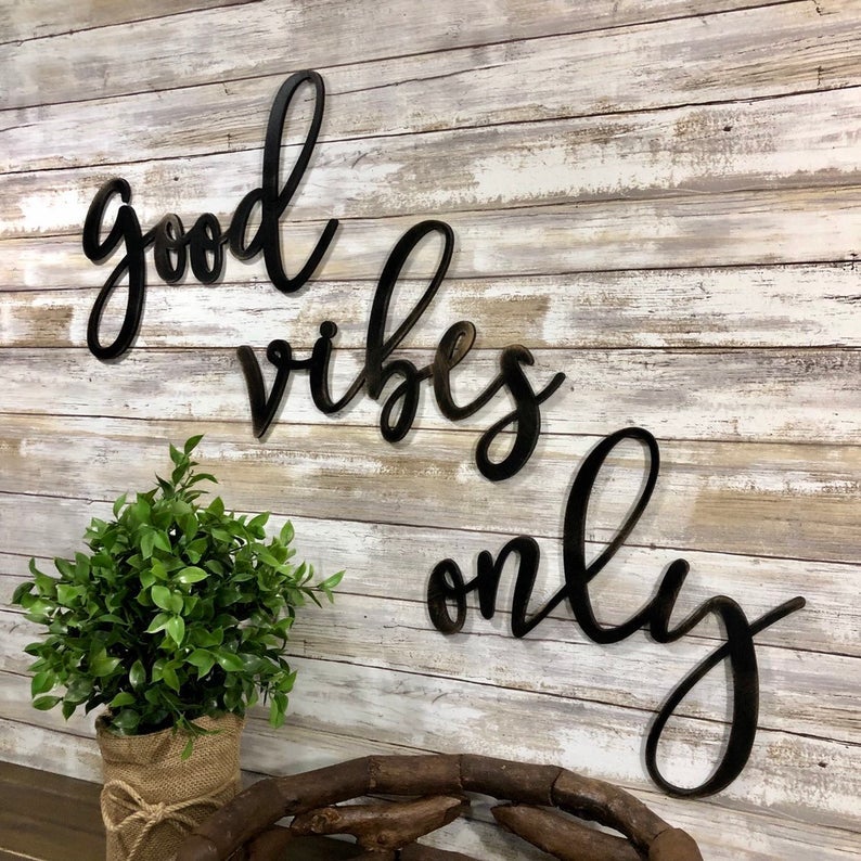 three black wood signs that say