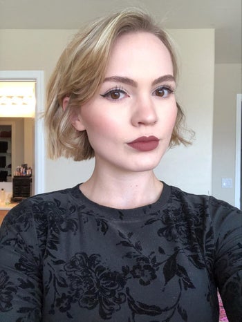 reviewer with the perfect cat eye after using the stamp