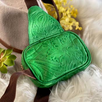 green belt bag with a floral design