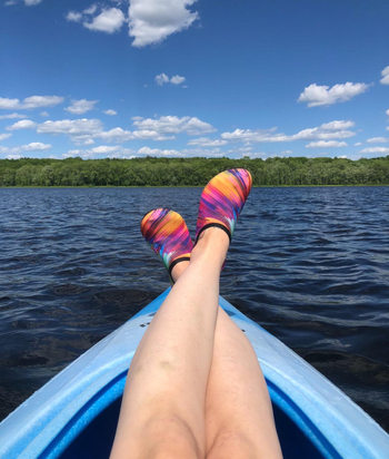 Reviewer pic of them wearing the shoes on top of a kayak