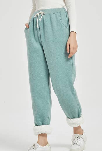 model wearing the joggers in light green