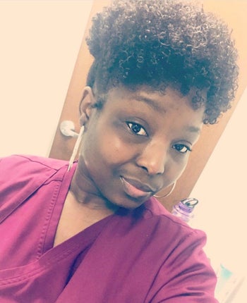 Reviewer showcasing their natural, curly hair after using the brush