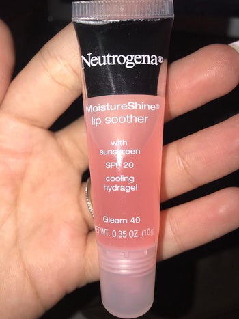 Reviewer holding lip soother gloss