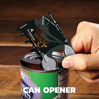 A person using the card to open a can