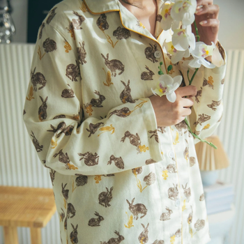 model wearing button up pajama set with closeup shot of rabbit print