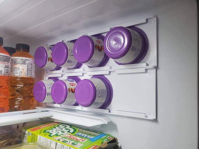 reviewer image of seven yogurts organized in the sliding trays mounted to the sides of the fridge