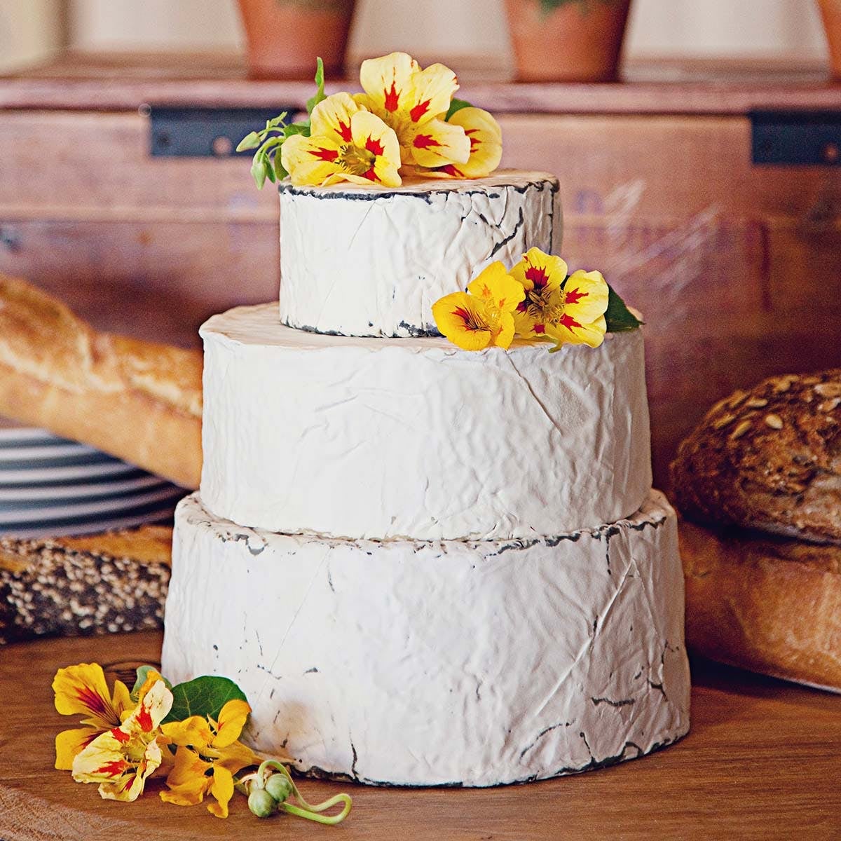 three soft cheeses on top of each other