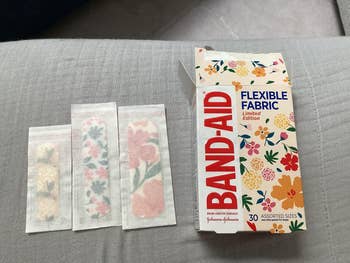 Band-Aid container with floral designs, 3 floral bandages displayed, portion of a constricted variation set