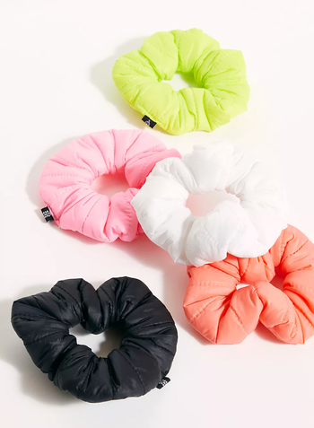 The puffer scrunchies in black, orange, pink, white, and green 
