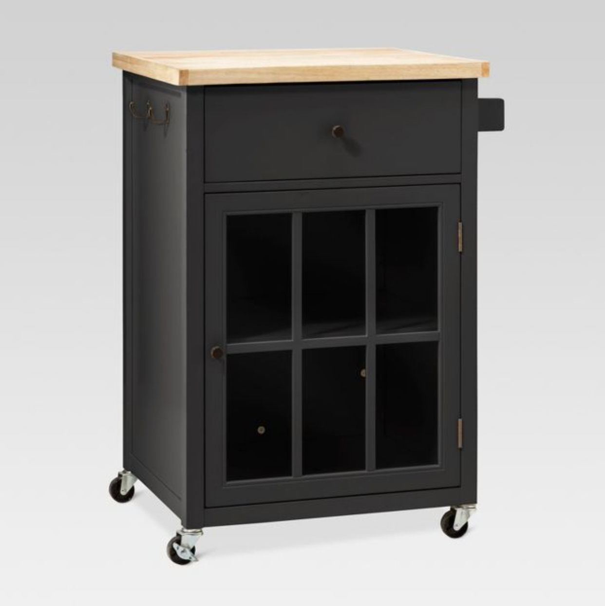 Black and light wooden microwave cart with side hooks and cabinet door and drawer on a white background