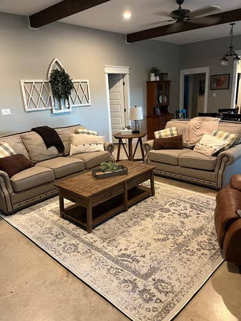 reviewer image of the ivory and silver rug in a living room