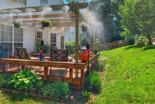 Reviewer's patio with with misting strategy   installed and lightly spraying 