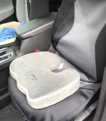 reviewer photo of the gray seat cushion on the seat of a car