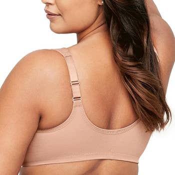 Model wearing a beige wireless bra, showcasing adjustable straps and creaseless  cloth  connected  the back.