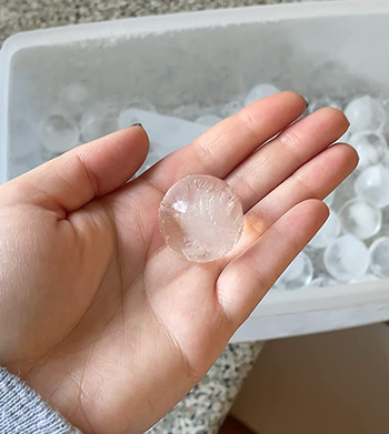 Reviewer holding small sphere of ice 