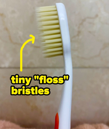 BuzzFeeder's photo of the toothbrush, with an arrow pointing towards the bristles with text: tiny 