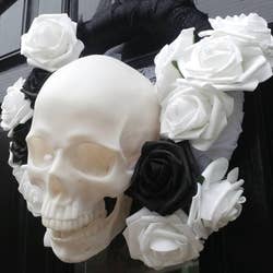 the skull in a black and white rose wreath