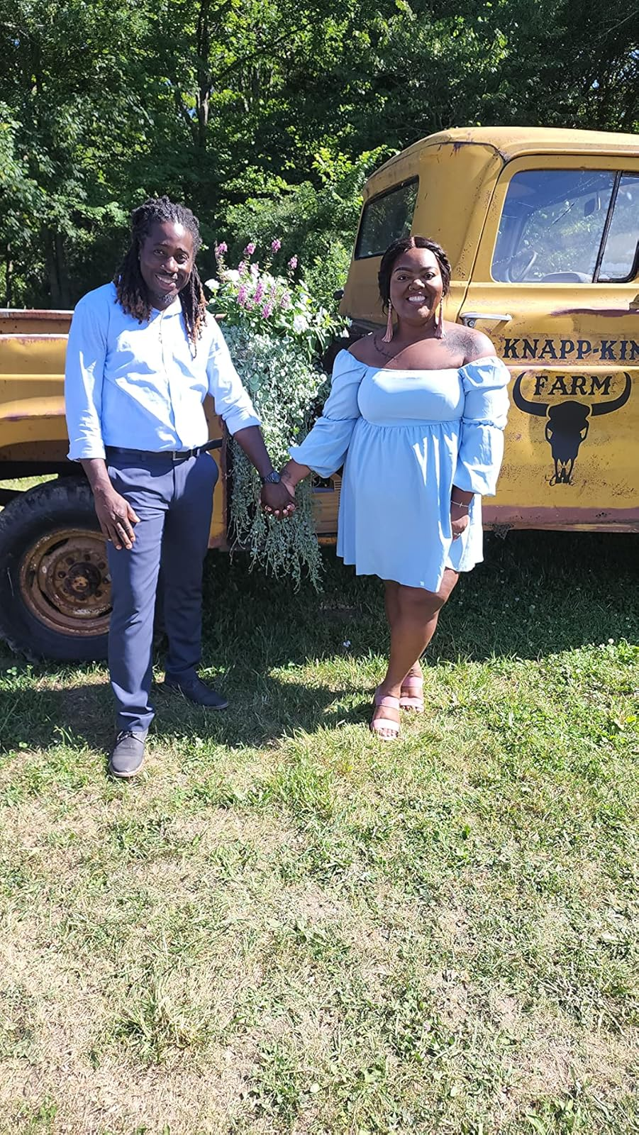 A reviewer wearing the dress off-the-shoulders in blue