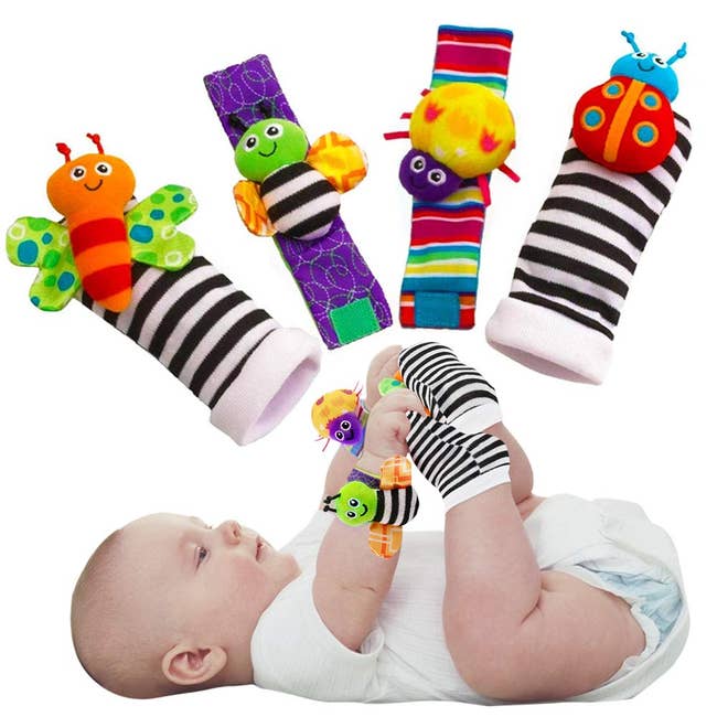 baby wearing the armbands and socks, which have stuffed animals swen onto them