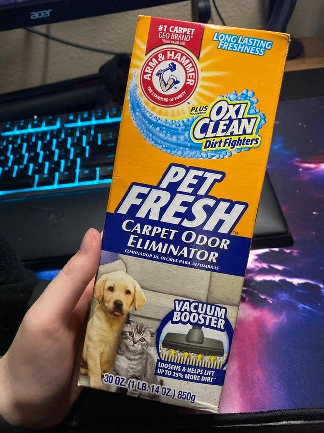 reviewer holding a box of pet deodorizer