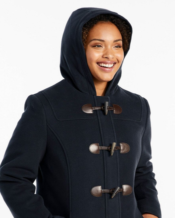 Close-up of model wearing the coat with hood on