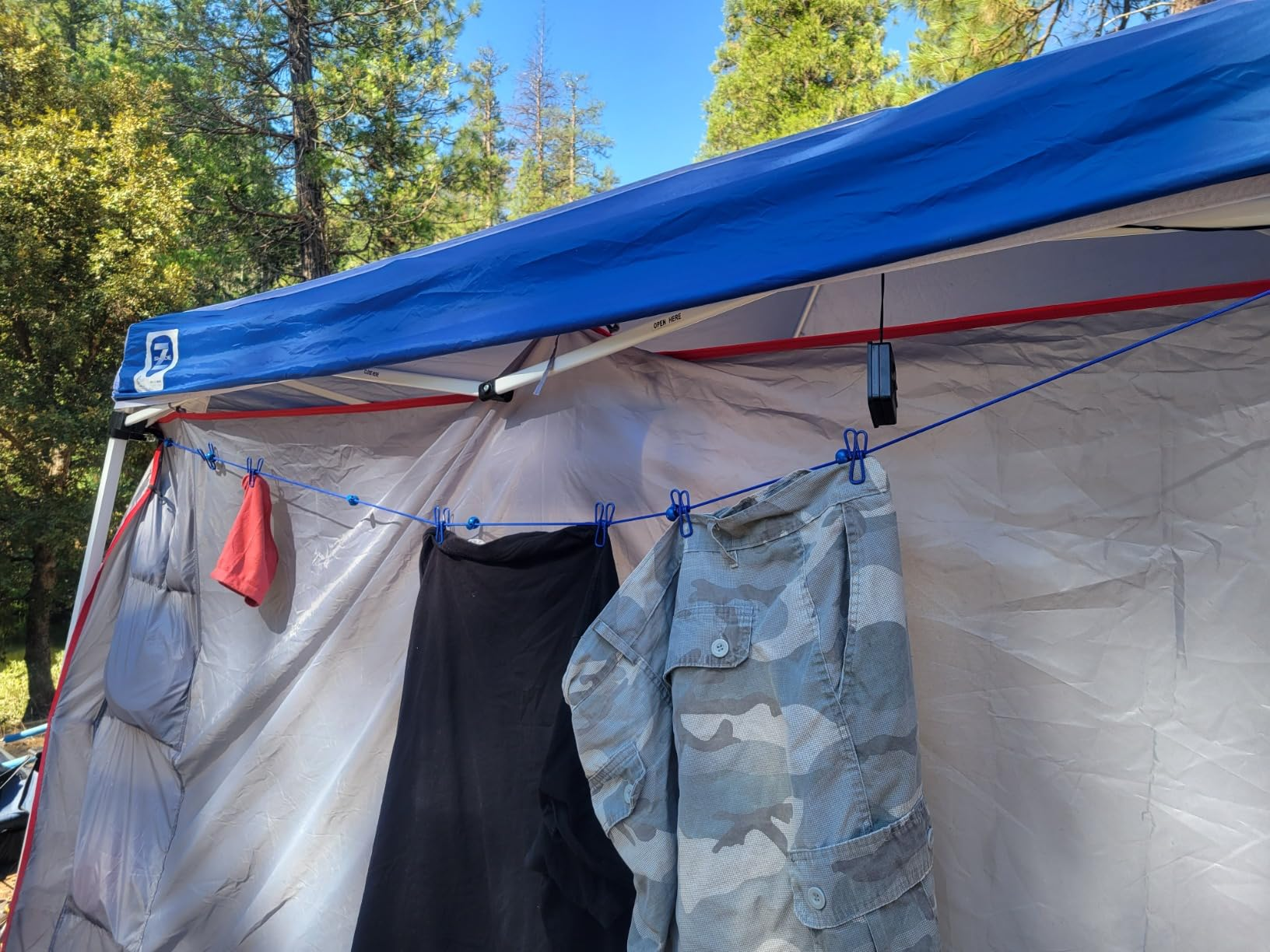 Clothesline with clothes hanging attached to the side of a camping tent