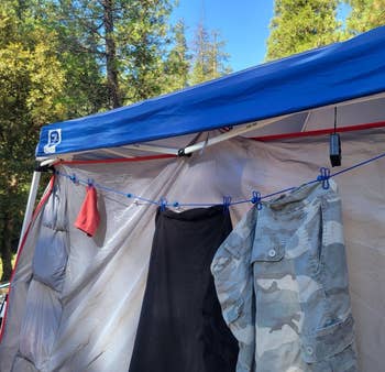 Clothesline with clothes hanging attached to the side of a camping tent