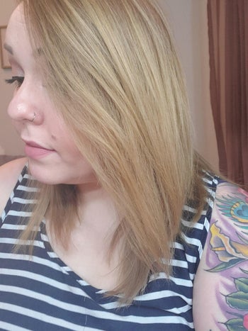 reviewer showing how straight their hair got using this tool