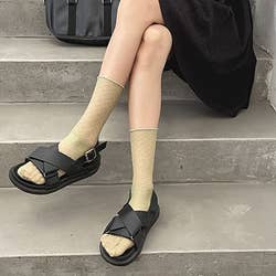 model wearing green socks with sandals