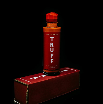 the hot sauce bottle on top of its box