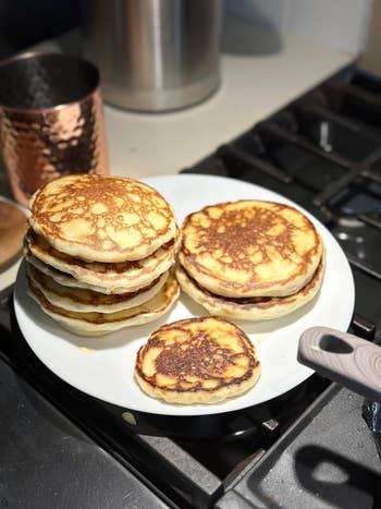 reviewer showing the perfect pancakes that were made with the mixer