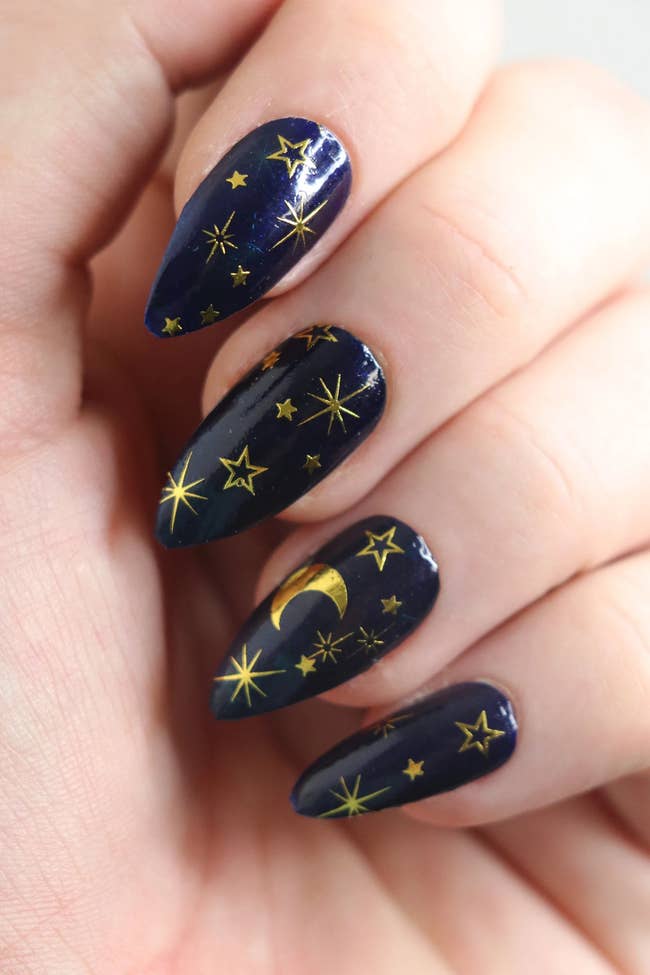 close up of nails with celestial decals on them