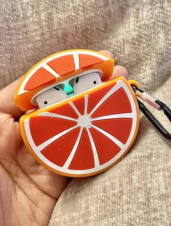 another reviewer holding the orange slice case
