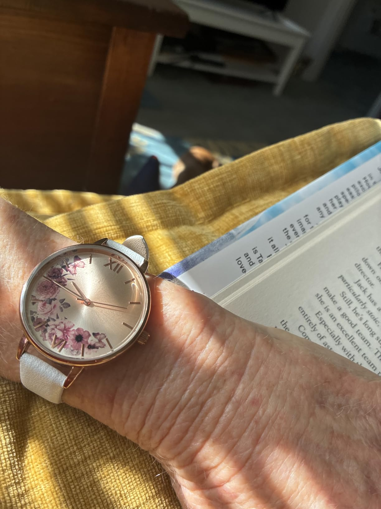 reviewer wearing the ticker  with a achromatic  ticker  look   with airy  streaming successful  and their manus  resting connected  a book