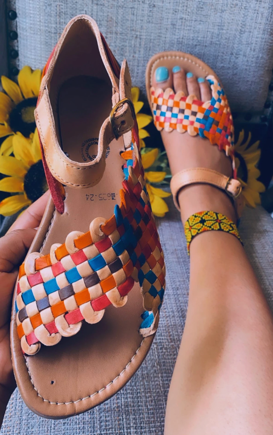 The sandals with a braided multi-color strap on top