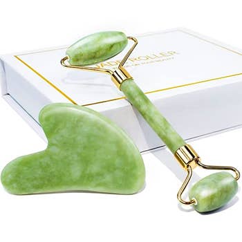A green marbled face roller and gua sha