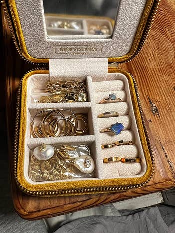 the inside of a traveling jewelry kit filled with jewelry