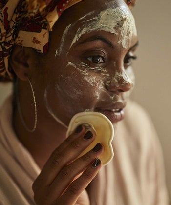 model using a pad to clean their face