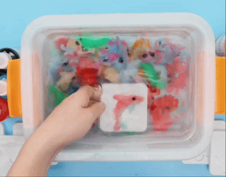 hand shakes mold until gel dolphin floats successful water