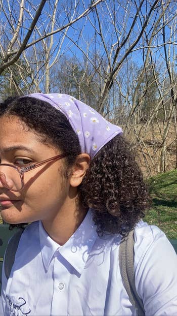 a reviewer wearing the purple floral bandana 
