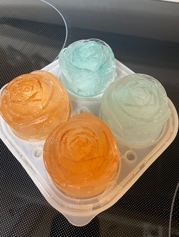 Four ice roses in the mold in various dyed colors 