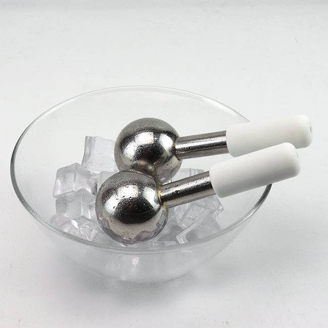 two steel globes in a bowl of ice