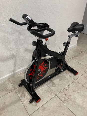 Red and black stationary bike in a reviewer's home