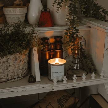 The candle is shown on a festive display case