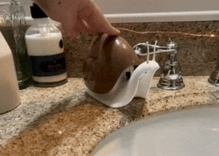 Gif of a person's hand using the snail-shaped soap dispenser
