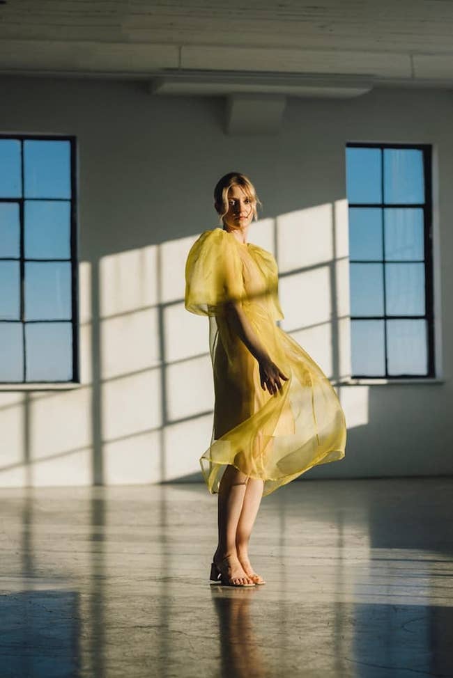 a model in a yellow silk organza gown