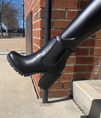 reviewer wearing the black boot
