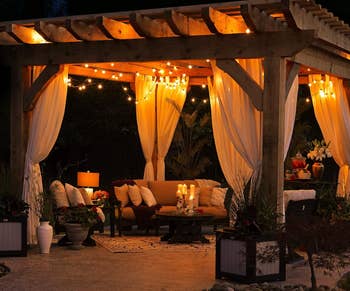 an open air canopy with string lights hanging from the ceiling