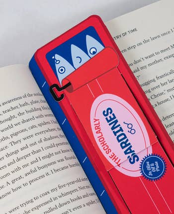 Fun sardine-themed bookmark on a book page with playful fish design and the words 